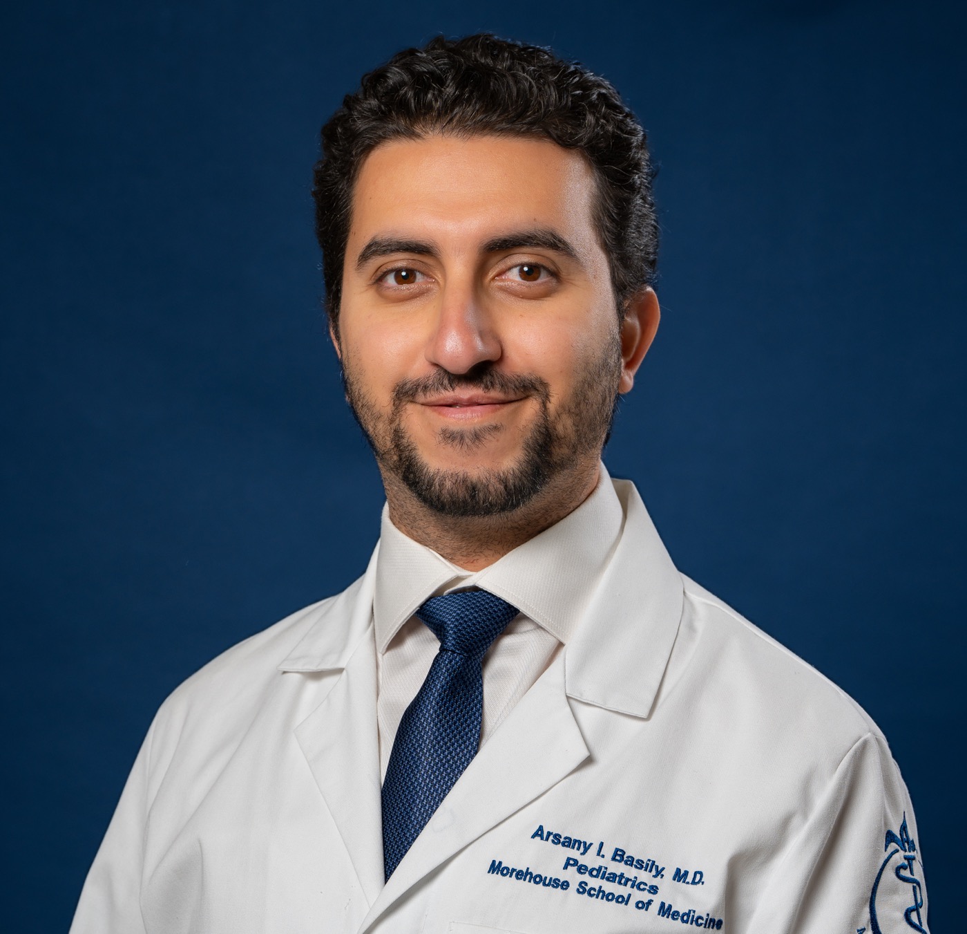Dr. Arsany Basily wearing a white coat